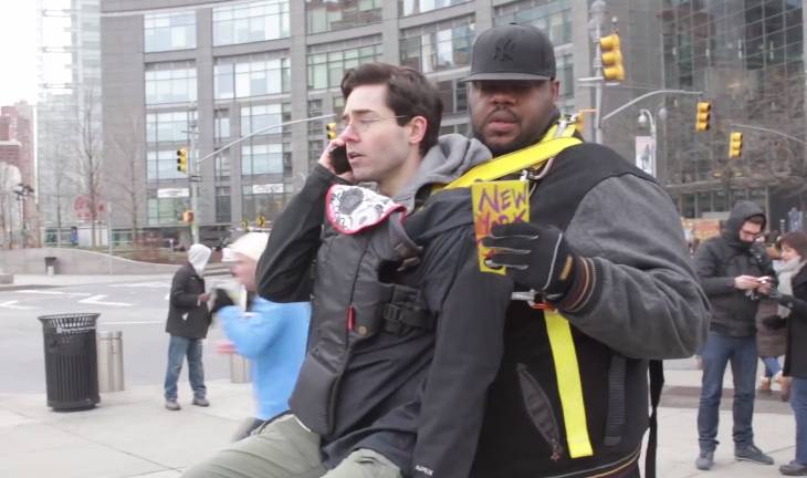 grown man in baby carrier