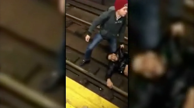 Watch This Crazed Man Get Run Over by a Train and Walk Away Unharmed